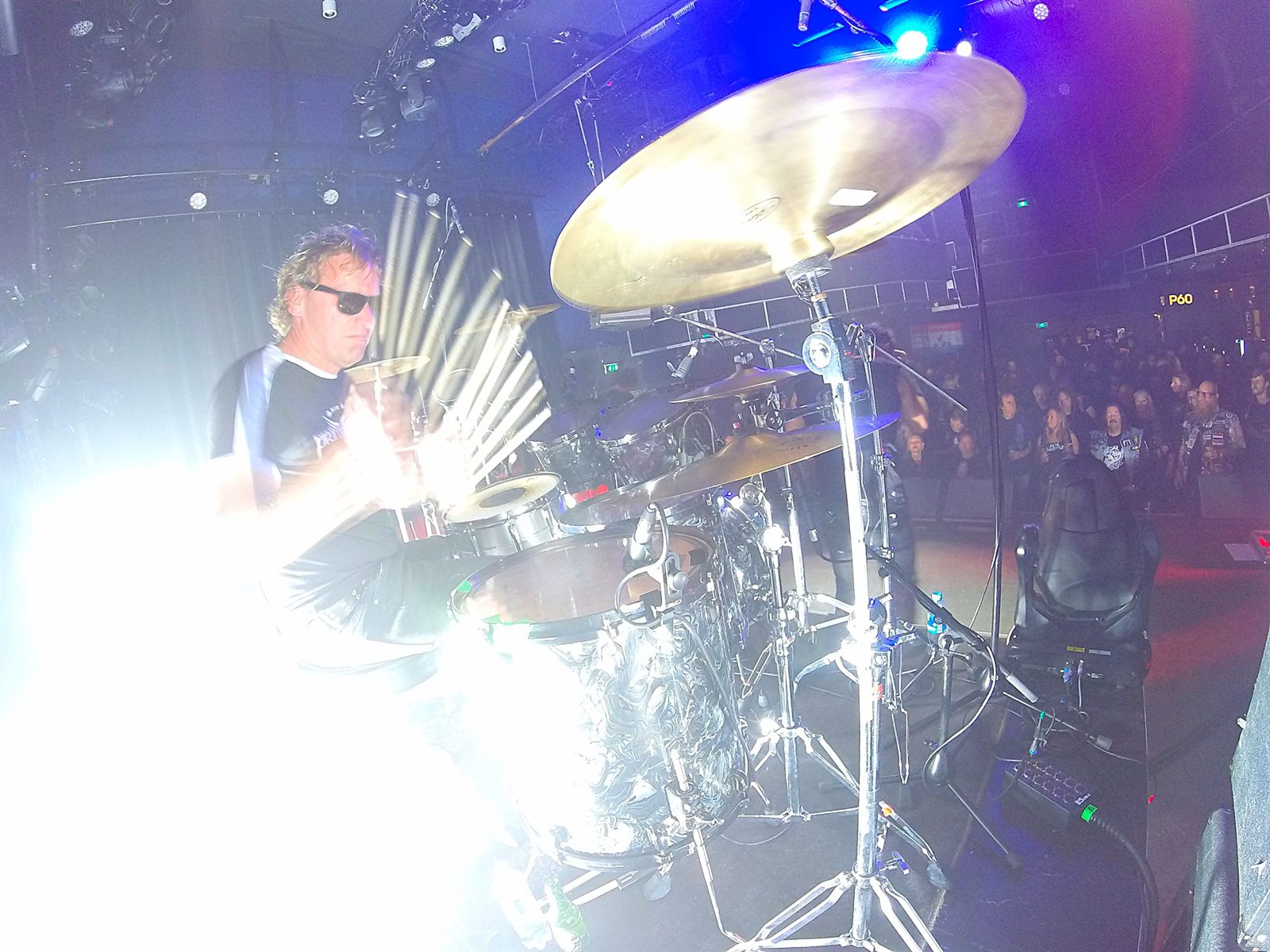 View from behind the drum kit towards a packed crowd