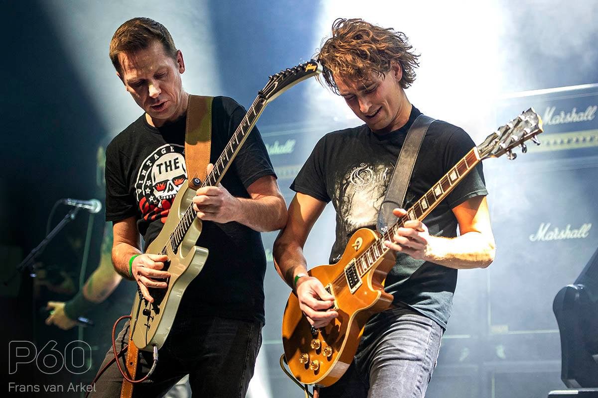 Two Black Knight guitarists playing side by side in front of Marshall stacks